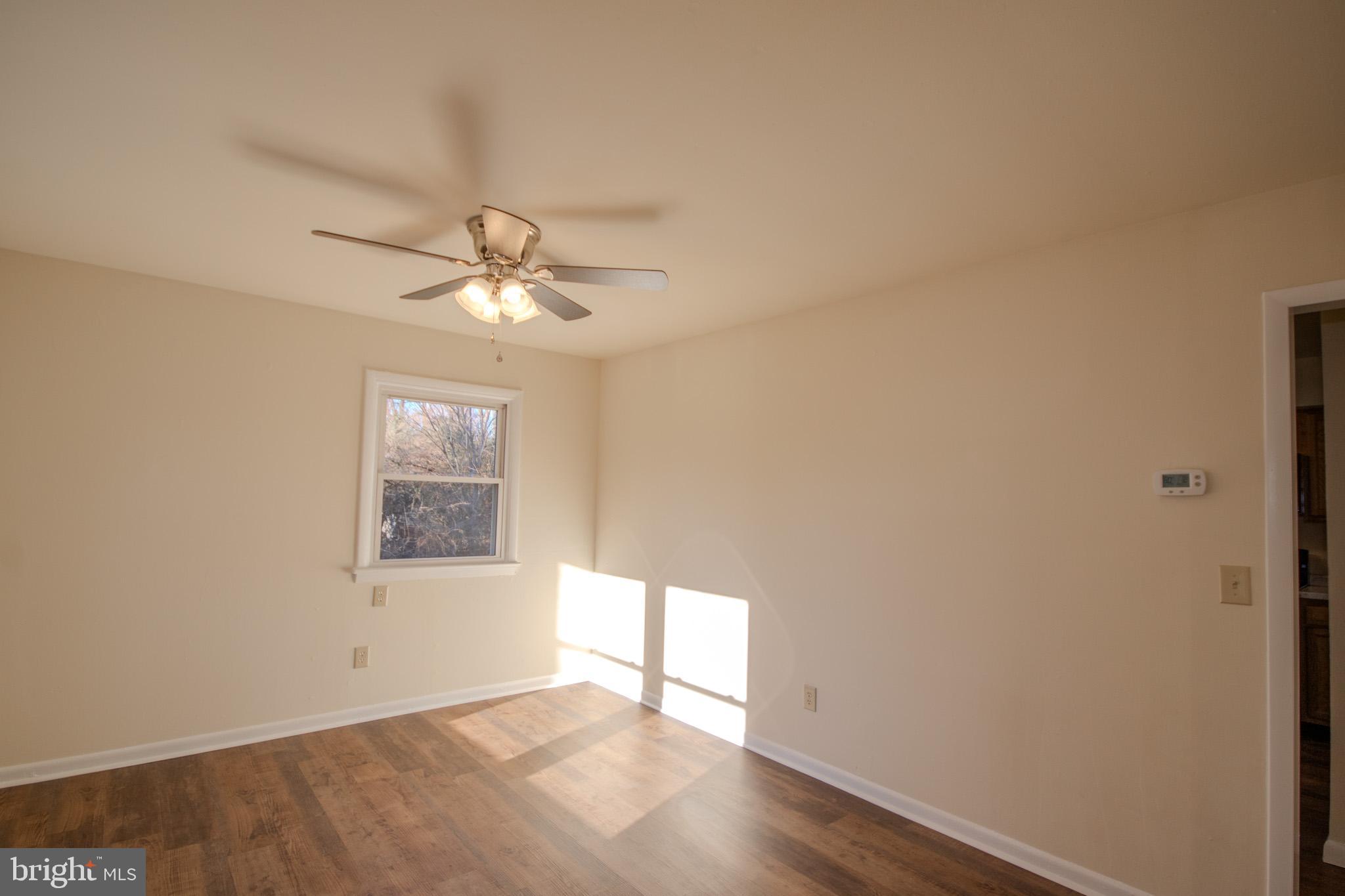 306 Autumn Terrace Salisbury, MD 21804 - Photo 4 of 21 an empty room with windows and fan
