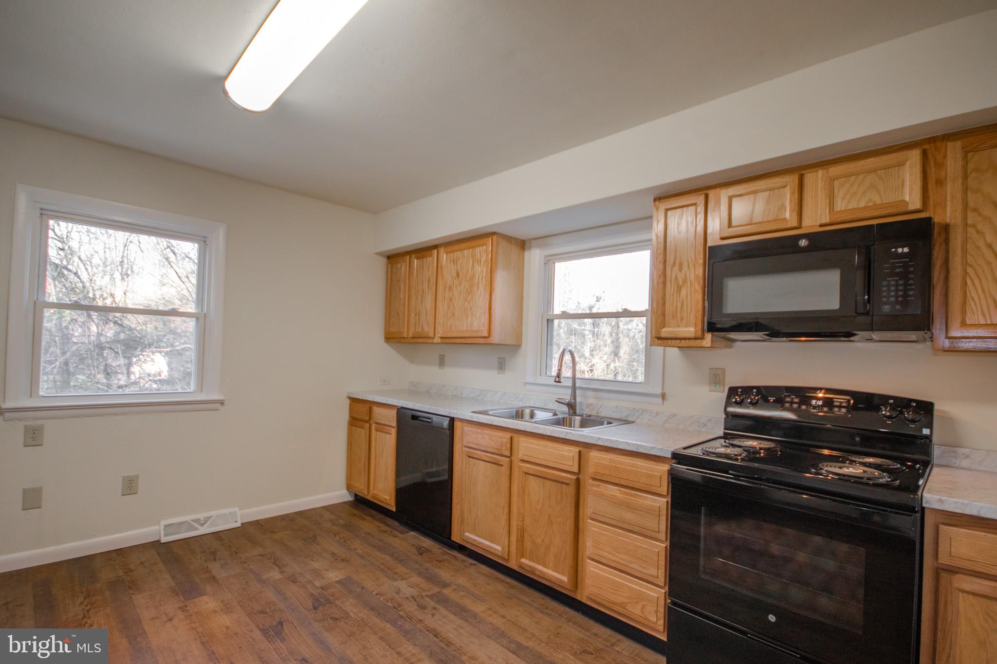 306 Autumn Terrace Salisbury, MD 21804 - Photo 7 of 21 a kitchen with stainless steel appliances a stove sink microwave and window