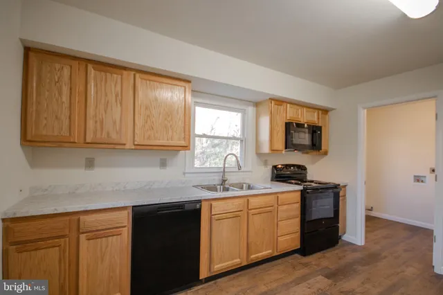 a kitchen with stainless steel appliances granite countertop a sink stove and microwave