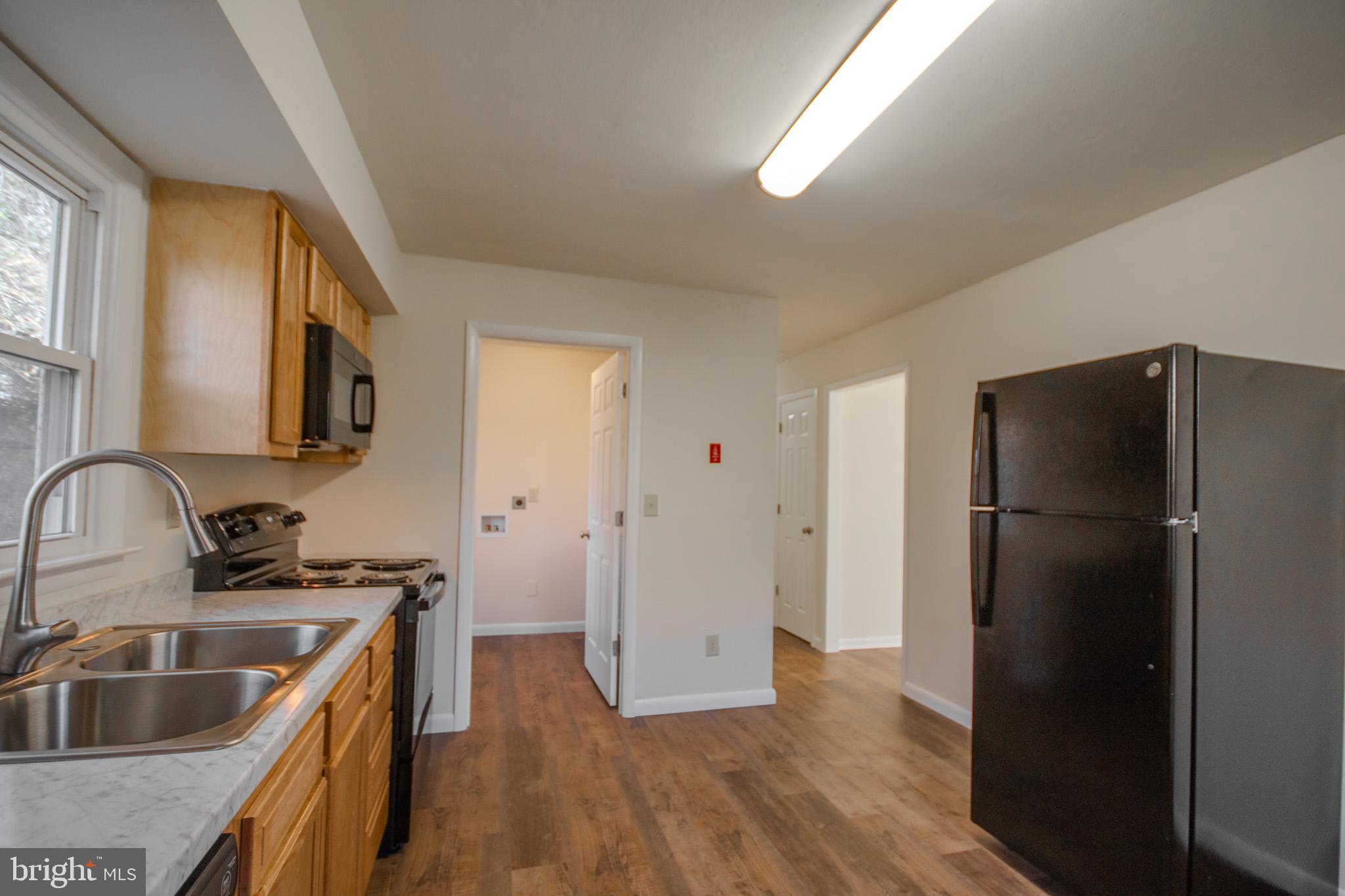 306 Autumn Terrace Salisbury, MD 21804 - Photo 9 of 21 a kitchen with a refrigerator sink and cabinets