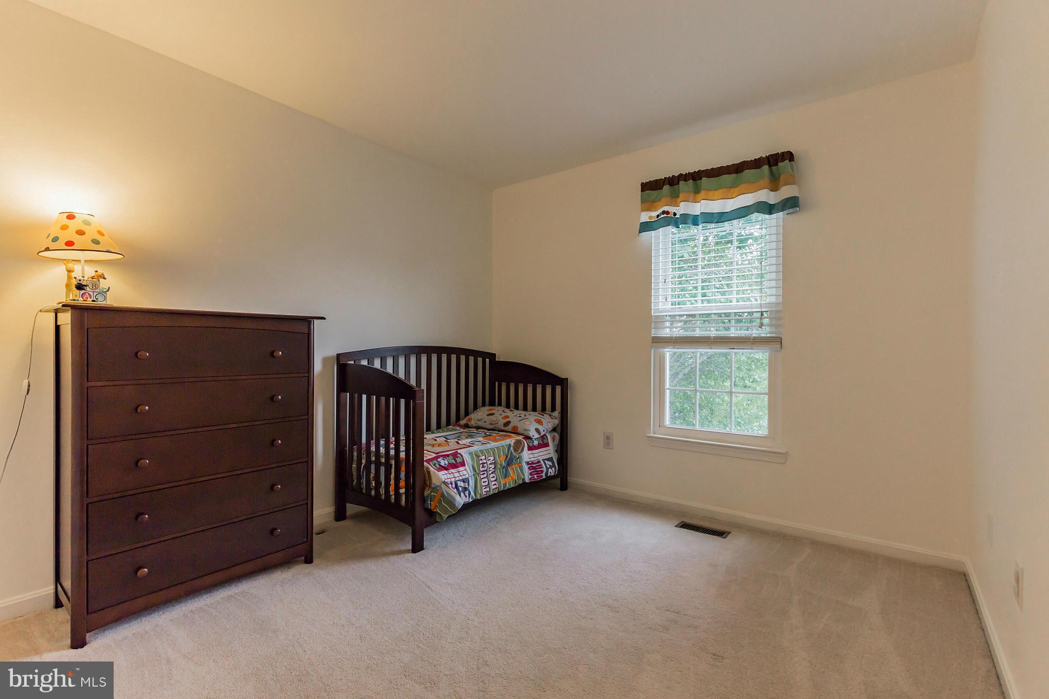 4436 Cole Farm Road Baltimore, MD 21236 - Photo 22 of 30 a bedroom with a bed and a window