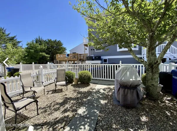 a view of a chairs and table in backyard