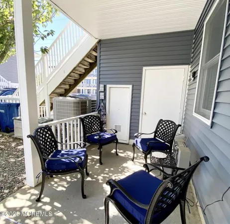 a balcony with wooden benches and a couch
