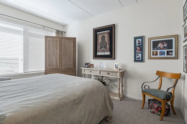 a bedroom with a bed and a desk