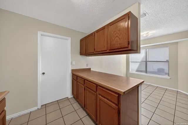 a kitchen with a sink cabinets and a window