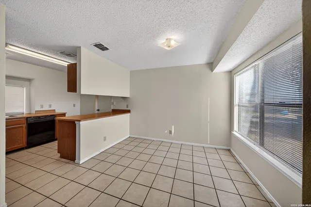 a large white kitchen with a stove a sink dishwasher and a refrigerator