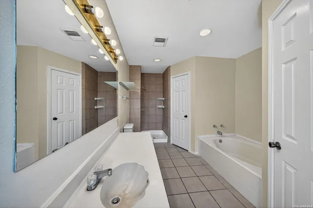 a bathroom with a tub sink and shower