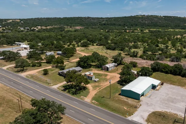 an aerial view of residential houses with city view