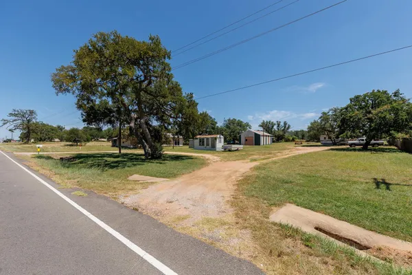 a view of yard with swimming pool and green space
