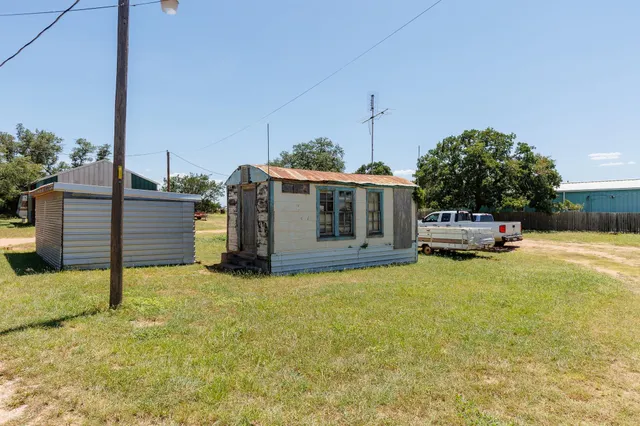 a view of a patio with a table chairs and a fire pit