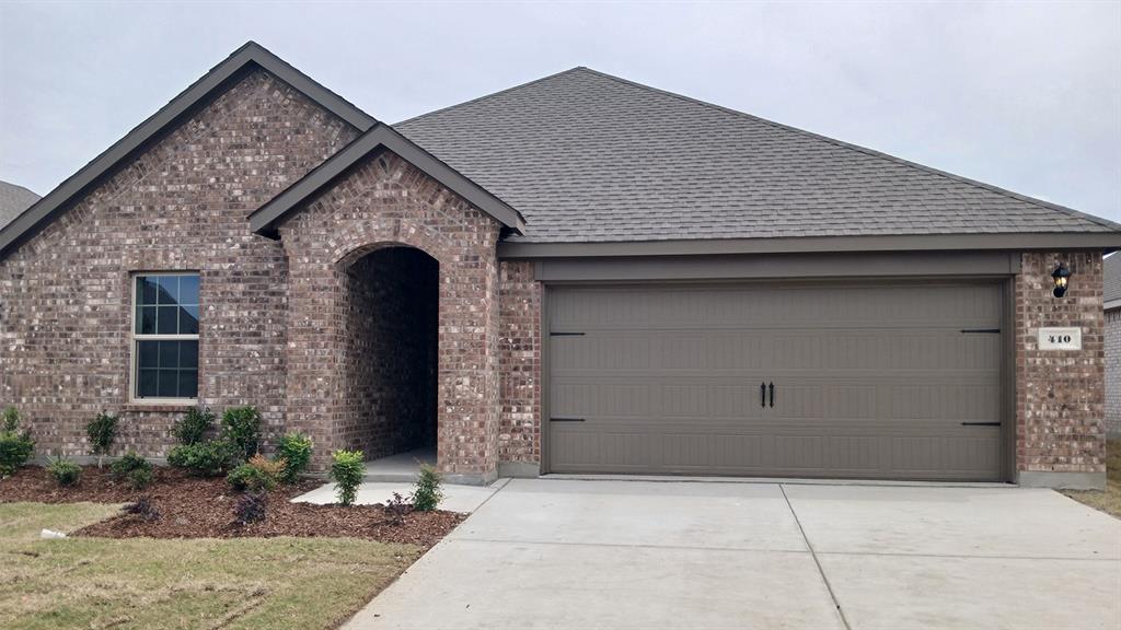 Brick exterior with a gabled roof and arched entryway