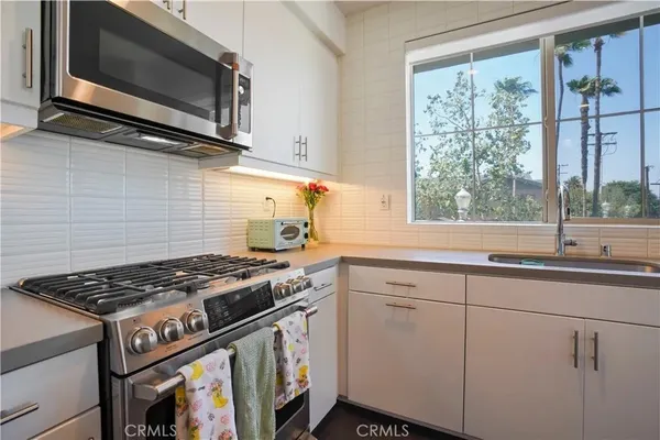 a kitchen with stainless steel appliances kitchen island a refrigerator and a stove top oven