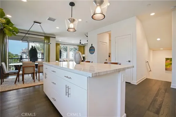 a kitchen with kitchen island granite countertop lots of counter top space and stainless steel appliances