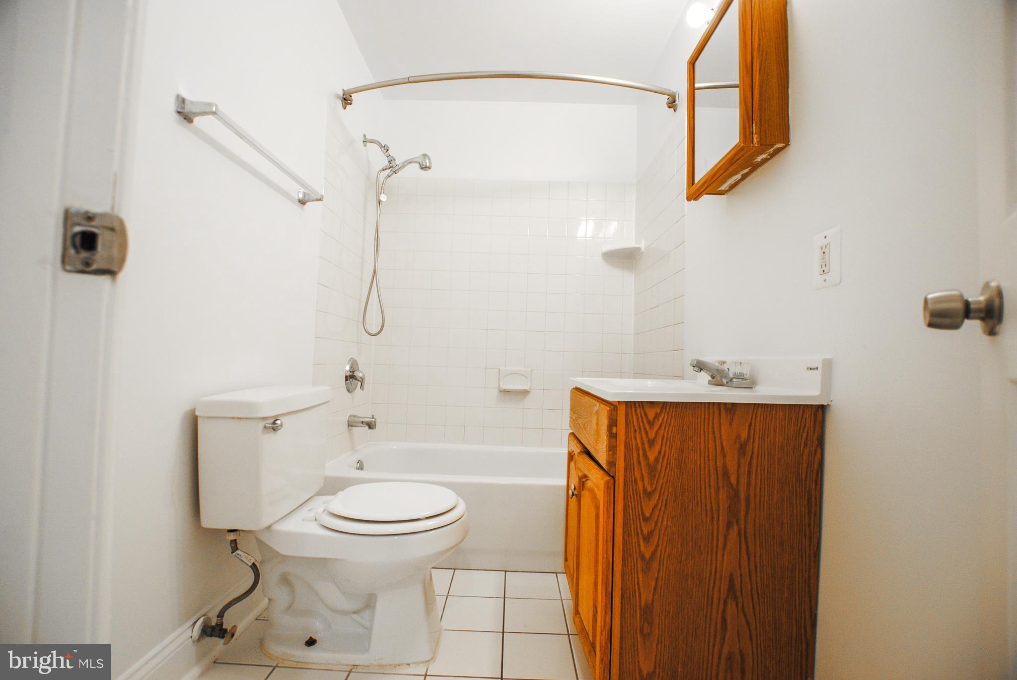 2210 Eutaw Place, Unit 3 Baltimore, MD 21217 - Photo 6 of 12 a bathroom with a toilet and a sink