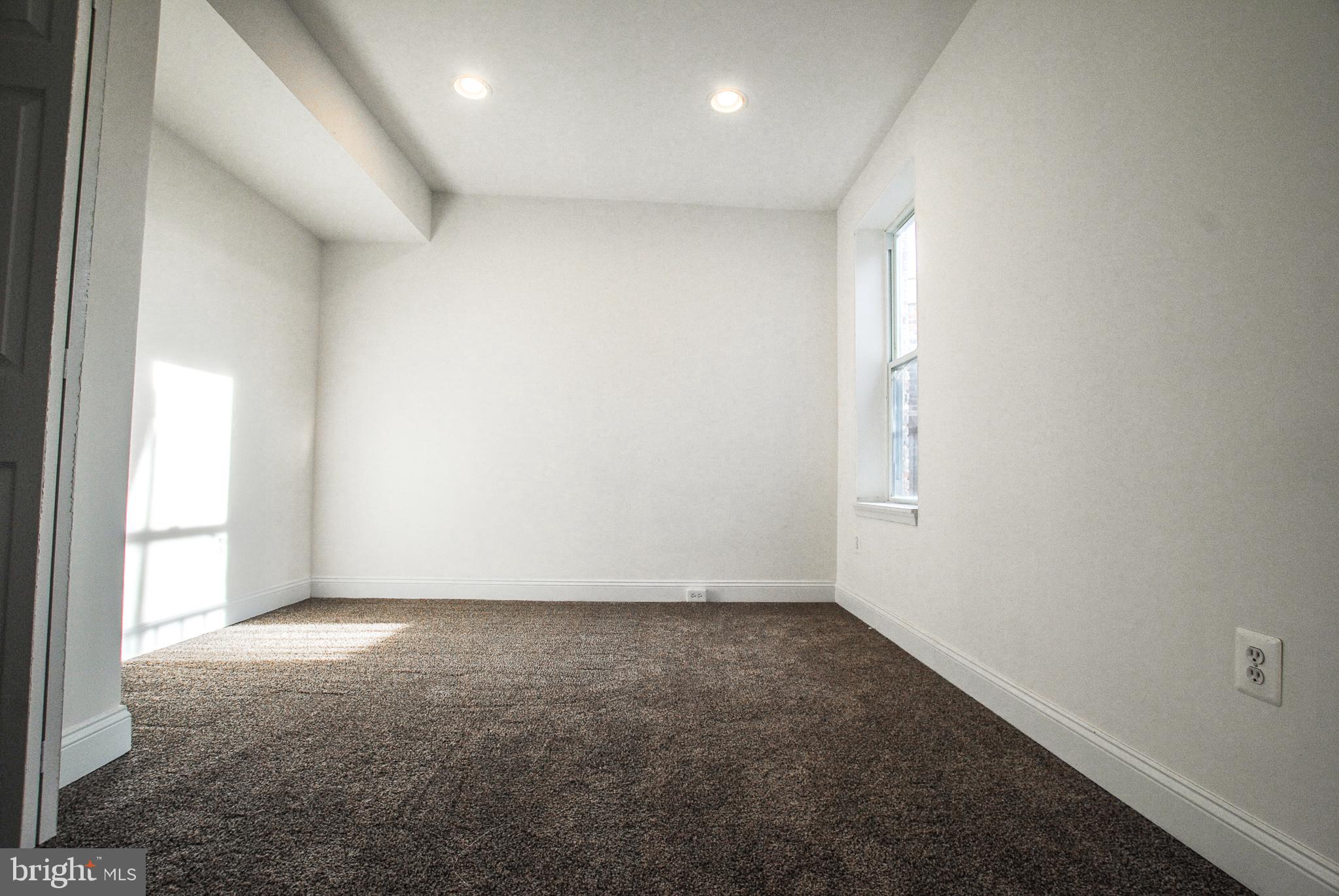 2210 Eutaw Place, Unit 3 Baltimore, MD 21217 - Photo 7 of 12 an empty room with a empty space and windows