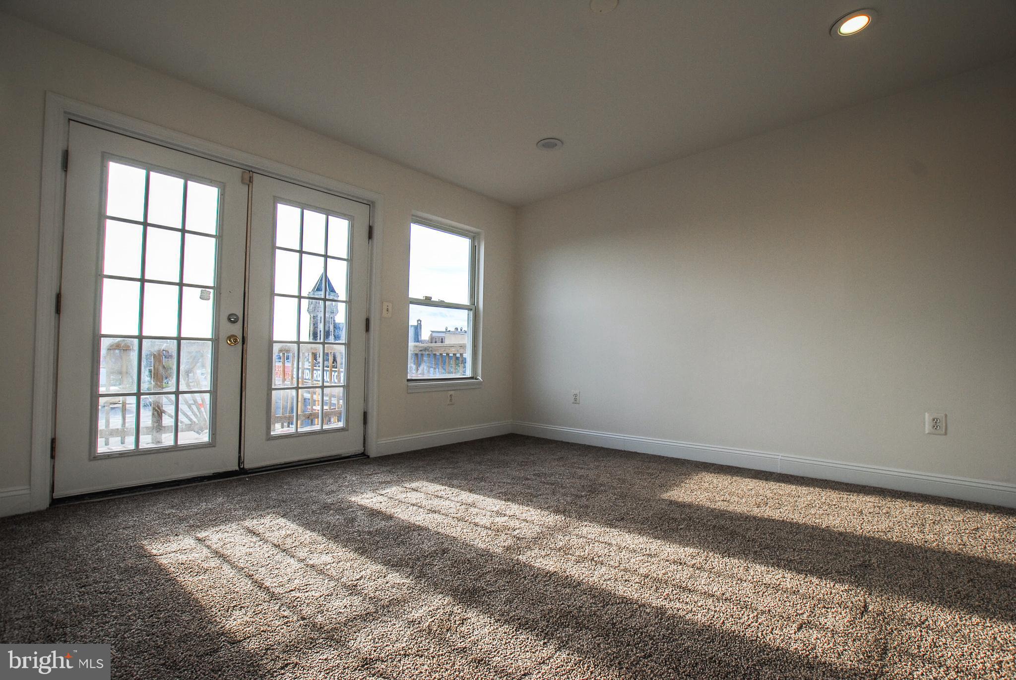 2210 Eutaw Place, Unit 3 Baltimore, MD 21217 - Photo 9 of 12 a view of an empty room with a window