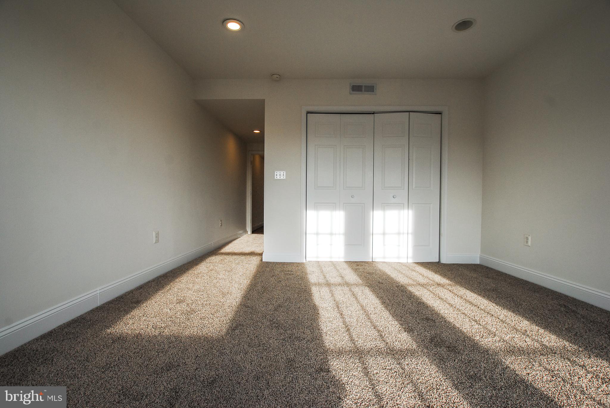 2210 Eutaw Place, Unit 3 Baltimore, MD 21217 - Photo 10 of 12 a view of a room with a closet and windows