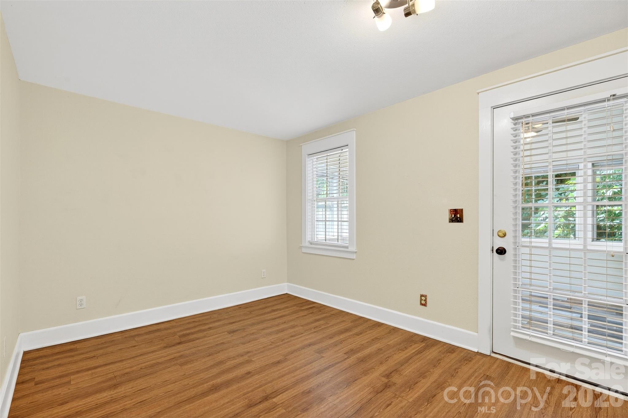160 East Howard Street Tryon, NC 28782 - Photo 31 of 48 a view of an empty room with wooden floor and a window