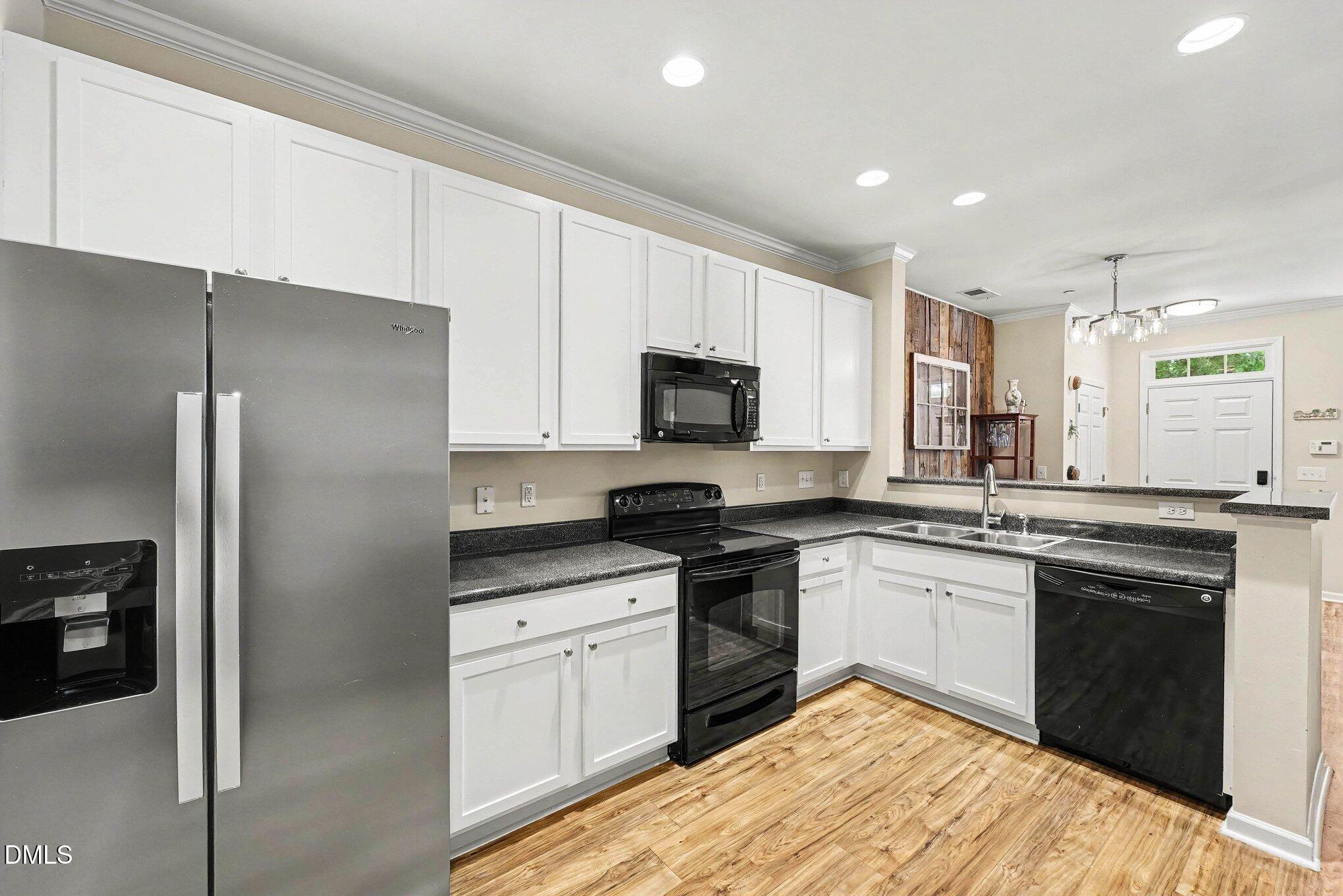 1130 Renewal Place, Unit 106 Raleigh, NC 27603 - Photo 10 of 34 a kitchen with a sink stove and refrigerator