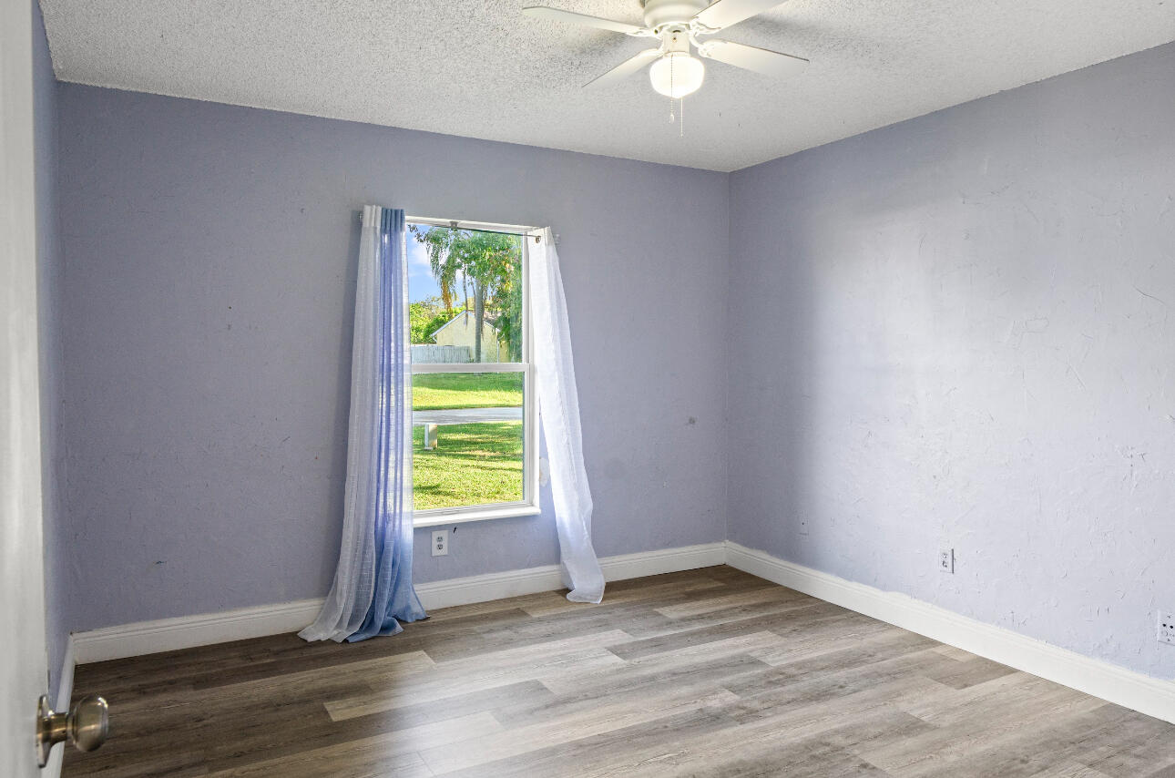 2230 Southeast Dill Lane Port St. Lucie, FL 34952 - Photo 11 of 15 wooden floor in an empty room with a window