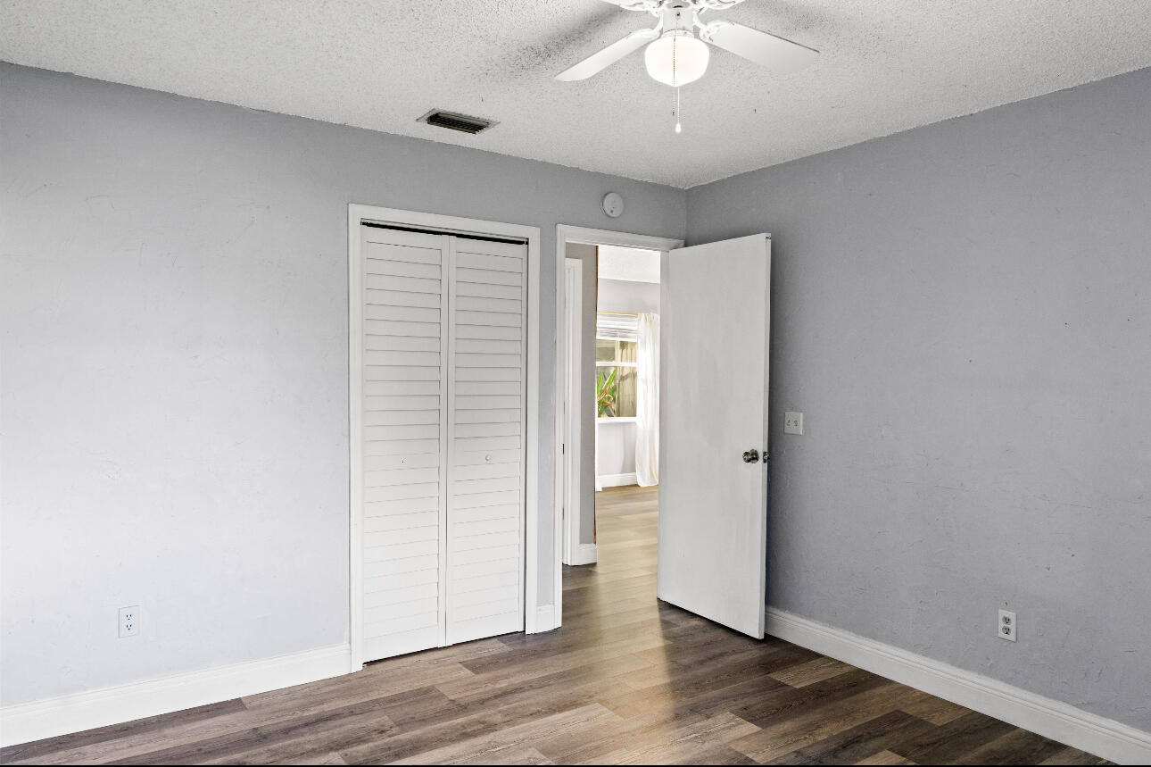 2230 Southeast Dill Lane Port St. Lucie, FL 34952 - Photo 9 of 15 wooden floor in an empty room with a window