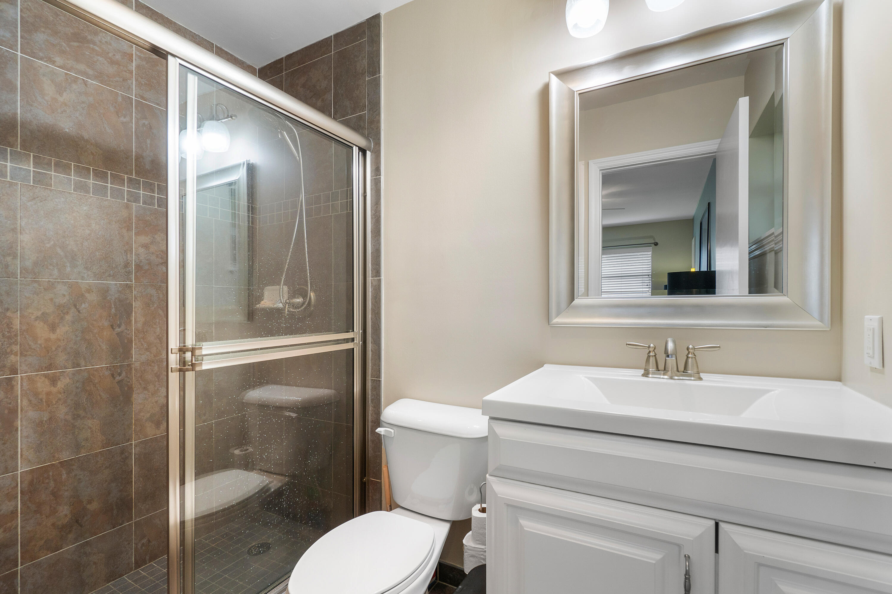 2757 Northeast 29th Avenue, Unit 2 Lighthouse Point, FL 33064 - Photo 17 of 29 a bathroom with a sink a toilet and shower