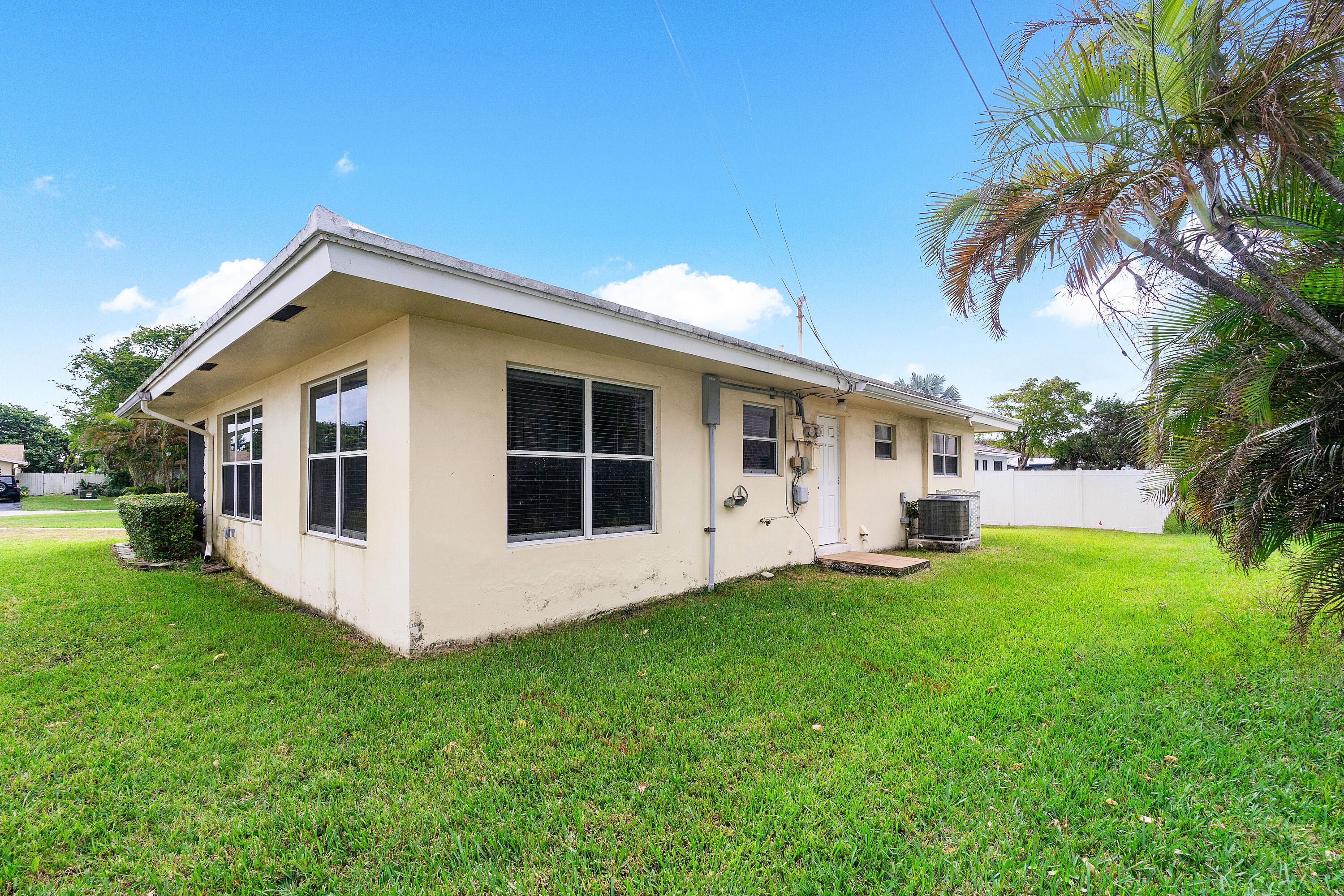 2757 Northeast 29th Avenue, Unit 2 Lighthouse Point, FL 33064 - Photo 26 of 29 a front view of house with yard and green space