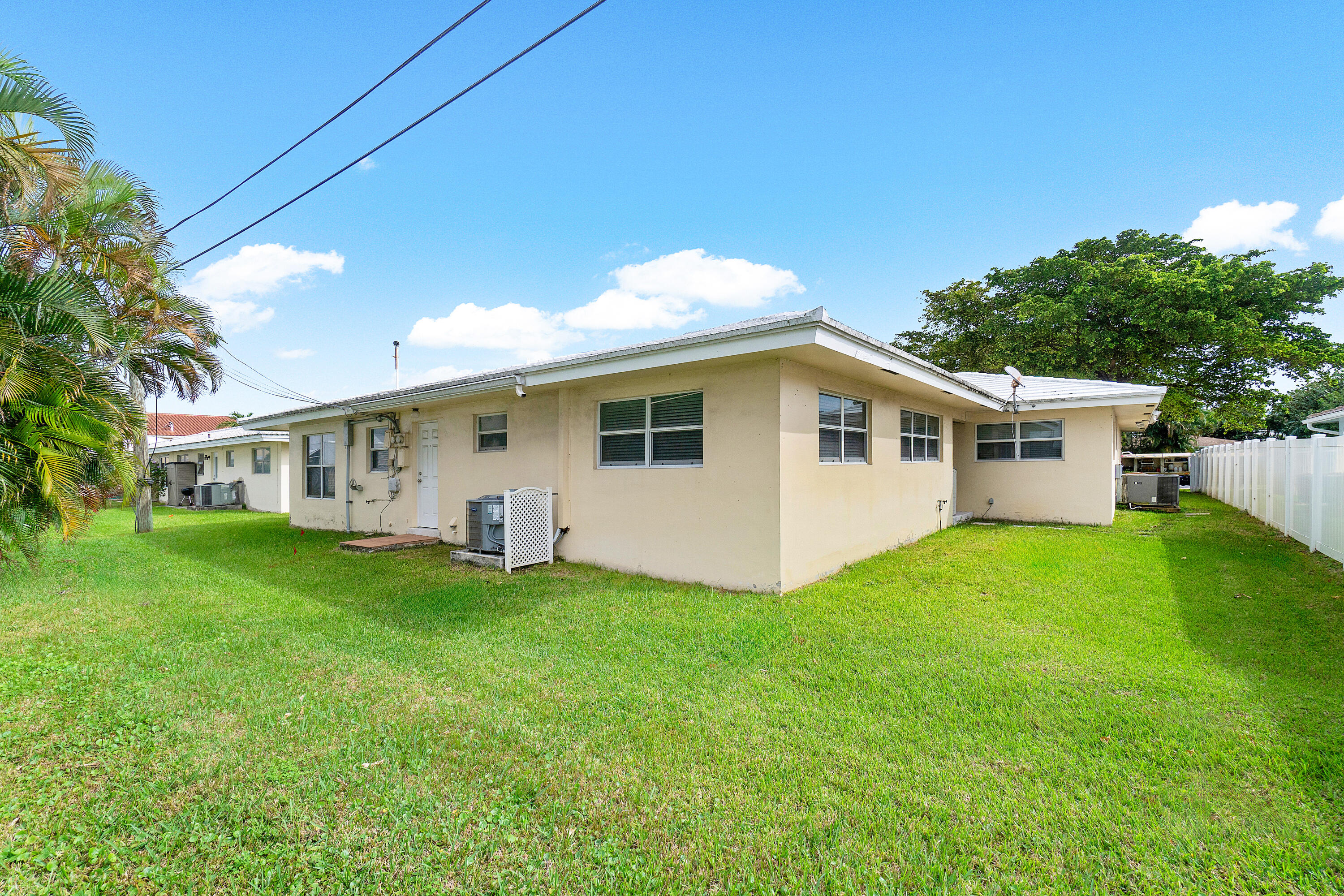 2757 Northeast 29th Avenue, Unit 2 Lighthouse Point, FL 33064 - Photo 27 of 29 a view of a house with a backyard