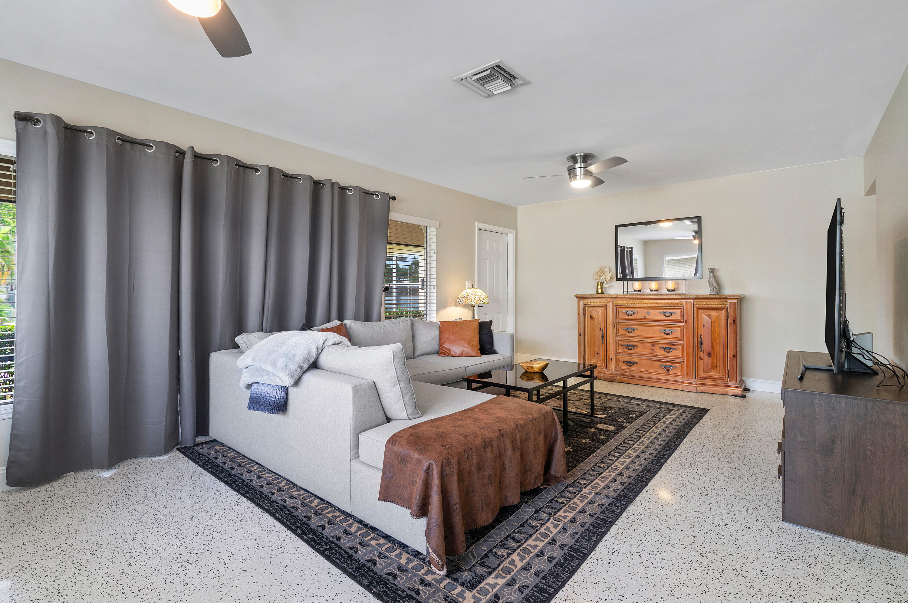 2757 Northeast 29th Avenue, Unit 2 Lighthouse Point, FL 33064 - Photo 8 of 29 a living room with furniture a flat screen tv and a refrigerator