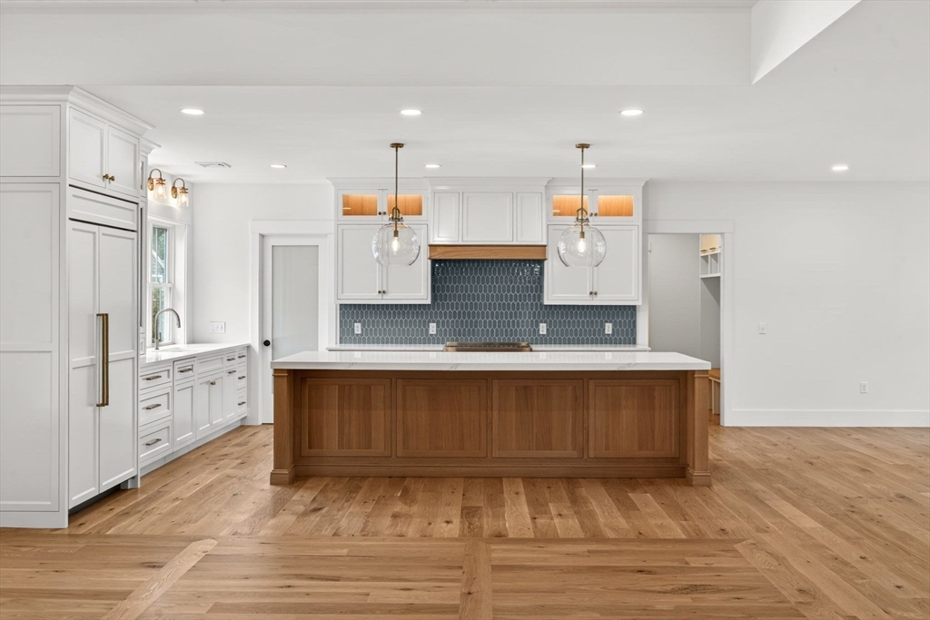 132 Great Western Road Harwich, MA 02645 - Photo 15 of 42 a large kitchen with stainless steel appliances a large counter top a stove a sink dishwasher and a refrigerator