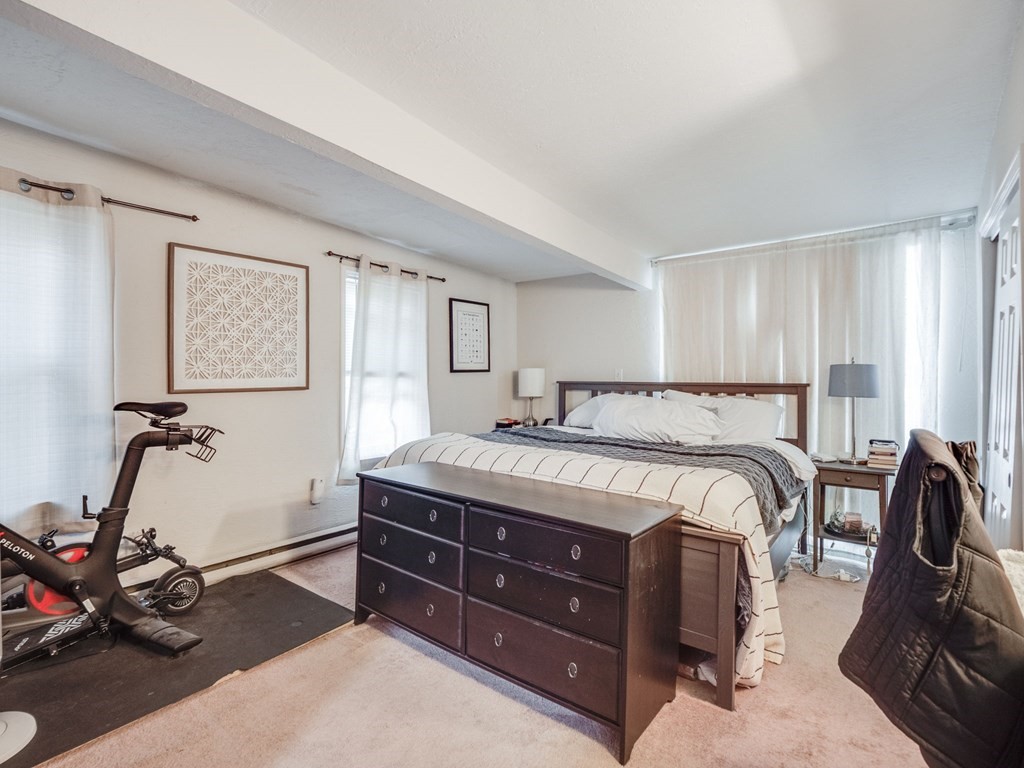 28 Mercer Street, Unit 2 Boston, MA 02127 - Photo 12 of 23 a spacious bedroom with a bed and wooden floor