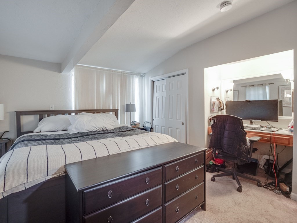 28 Mercer Street, Unit 2 Boston, MA 02127 - Photo 13 of 23 a bedroom with a bed and a chair