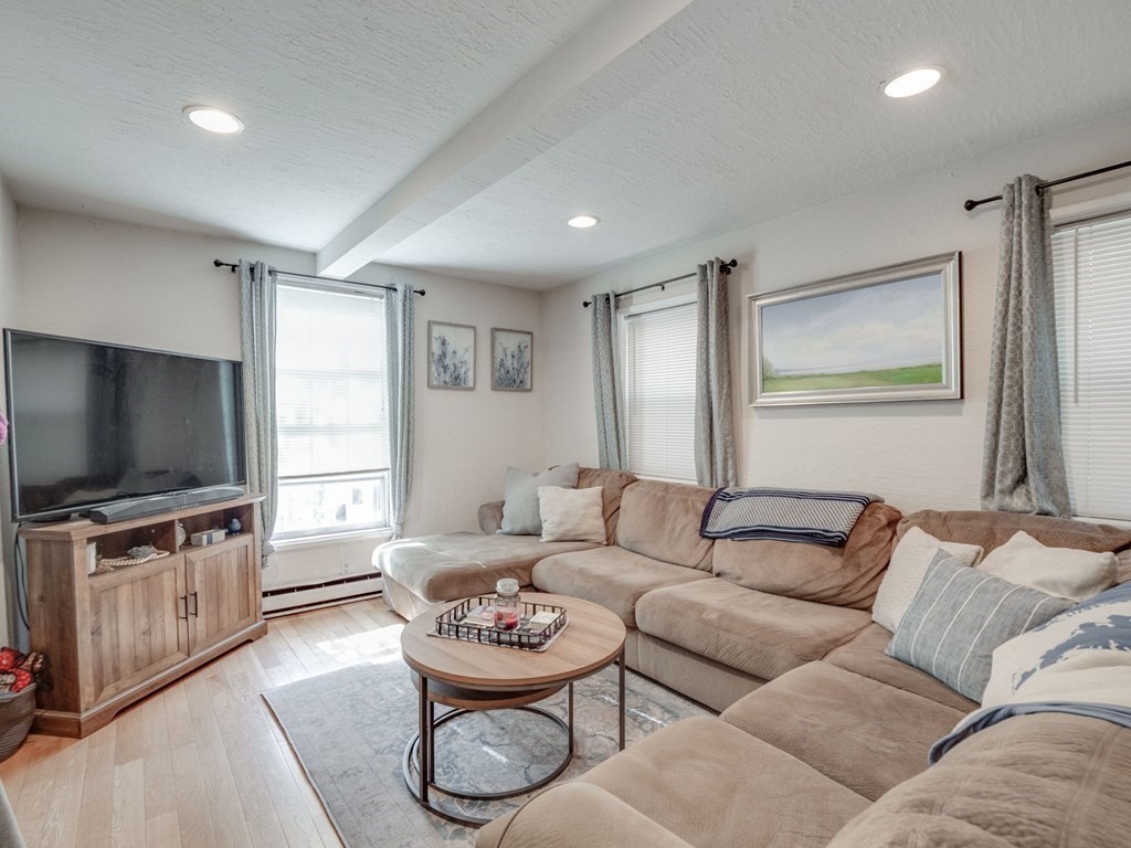 28 Mercer Street, Unit 2 Boston, MA 02127 - Photo 2 of 23 a living room with furniture and a flat screen tv