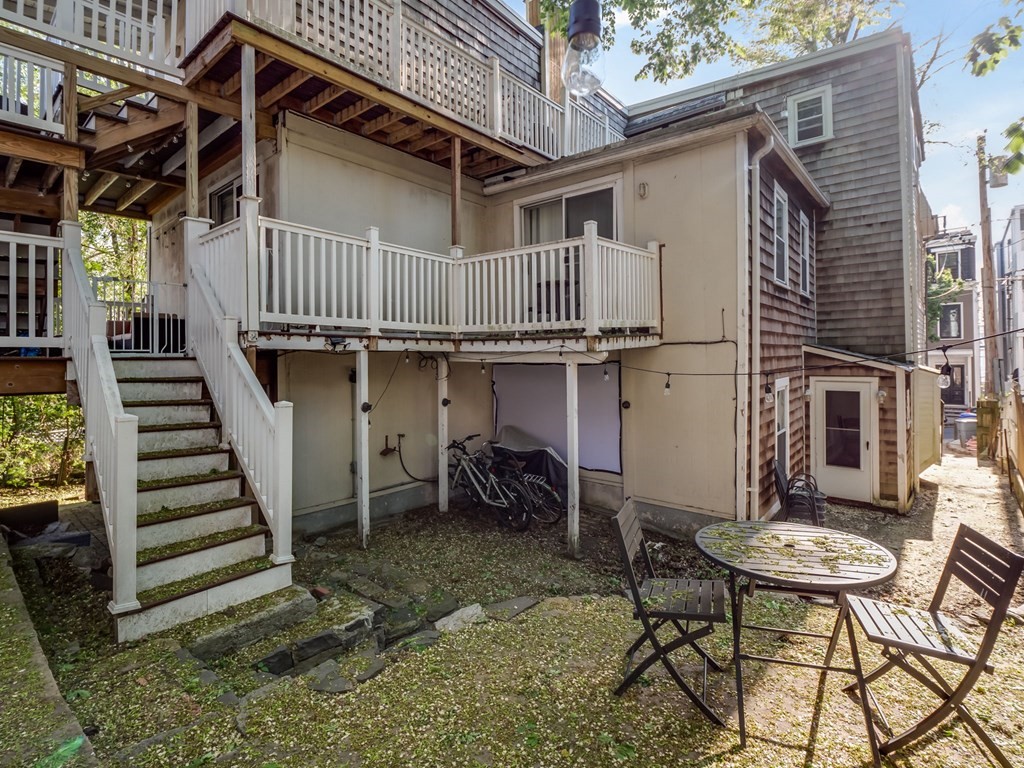 28 Mercer Street, Unit 2 Boston, MA 02127 - Photo 22 of 23 a backyard of a house with table and chairs