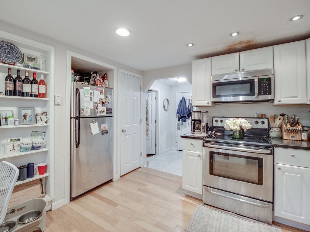 28 Mercer Street, Unit 2 Boston, MA 02127 - Photo 10 of 23 a kitchen with stainless steel appliances granite countertop a refrigerator and a stove top oven
