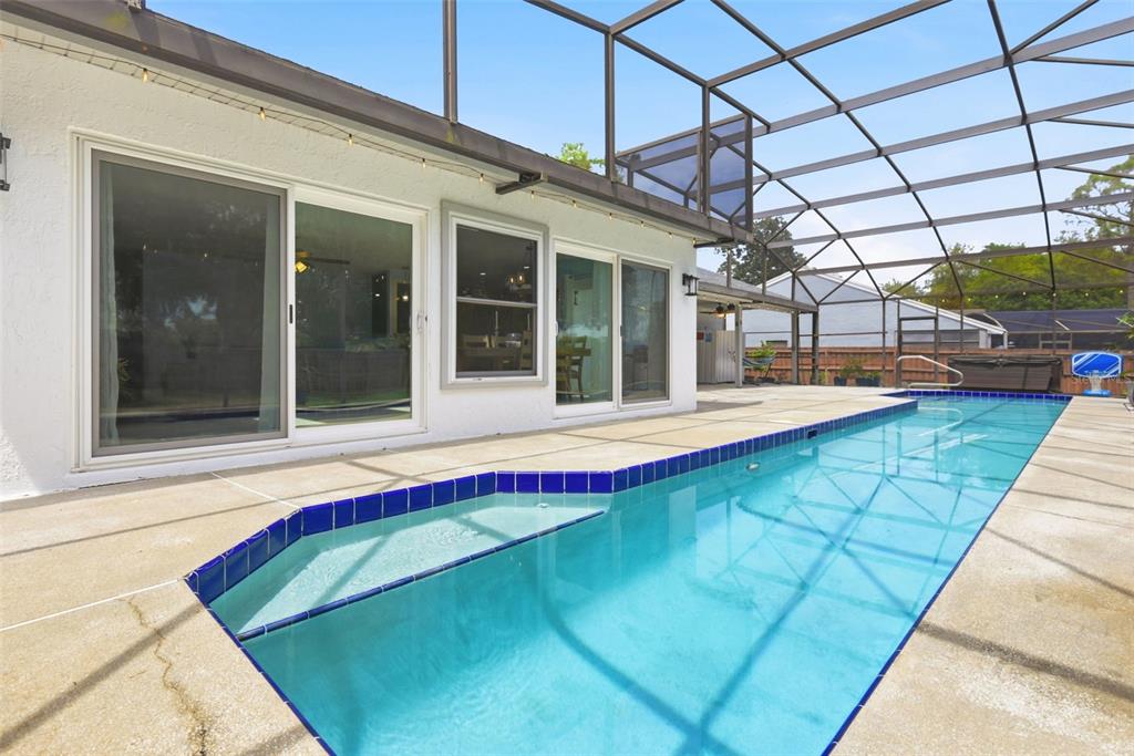7432 Sparkling Lake Road Orlando, FL 32819 - Photo 34 of 54 a view of a backyard with a swimming pool
