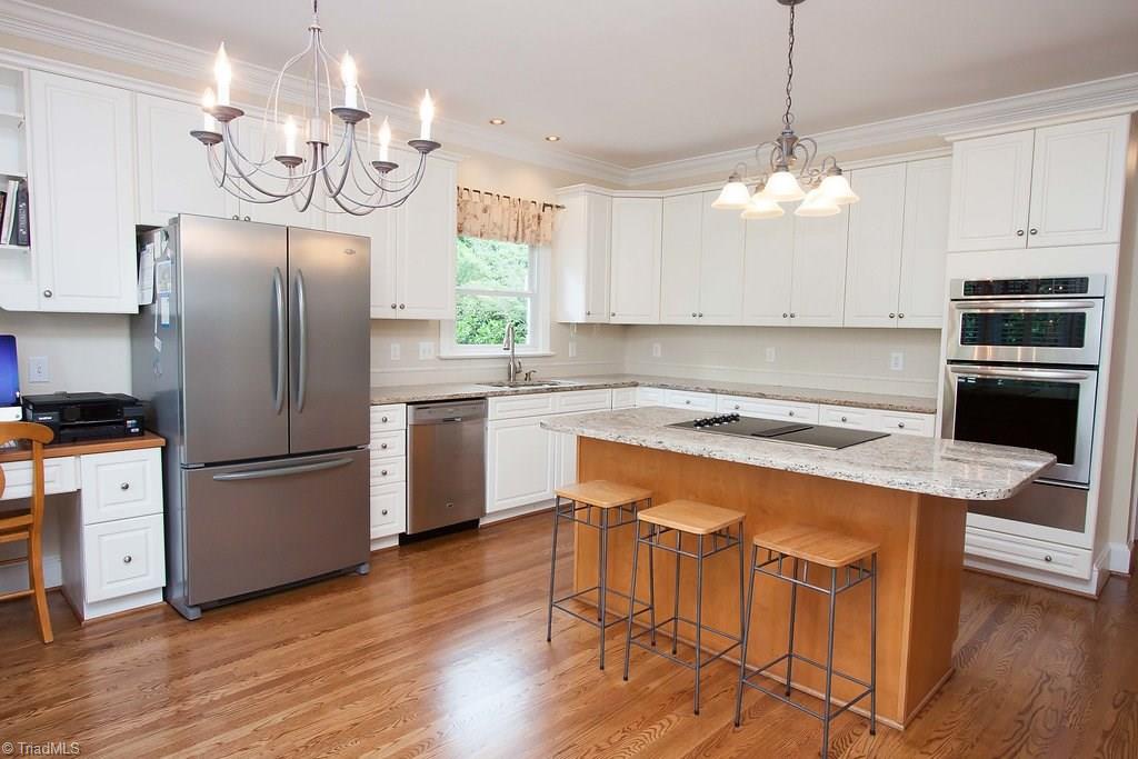 6104 Gwynedd Road Summerfield, NC 27358 - Photo 11 of 30 Island seating is available as well as plenty of room for table seating.
