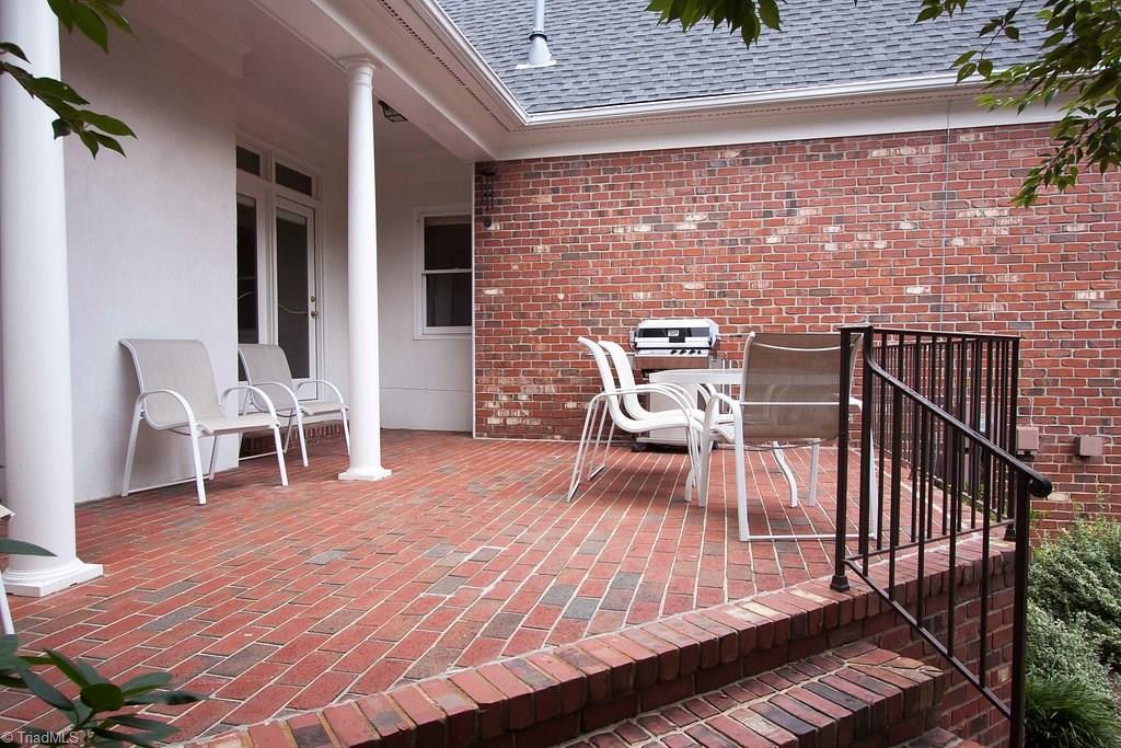 6104 Gwynedd Road Summerfield, NC 27358 - Photo 27 of 30 Covered porch overlooks amazing garden , complete with perennials, fish pond and fruit trees. Enjoy the outdoors like never before!