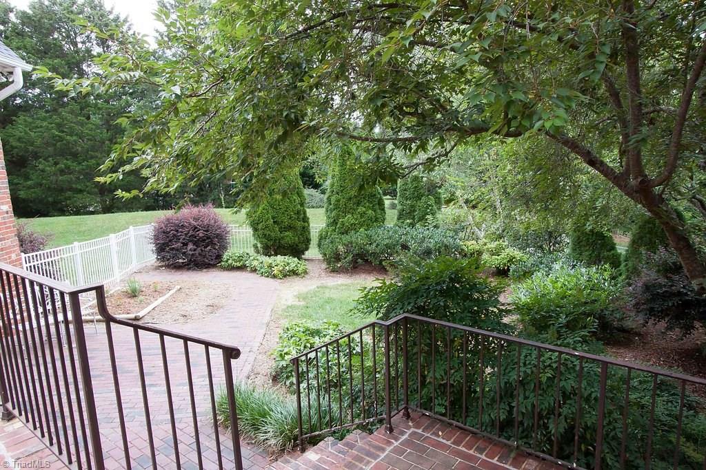 6104 Gwynedd Road Summerfield, NC 27358 - Photo 28 of 30 Magical mix of textures and colors! Custom wrought iron railing.