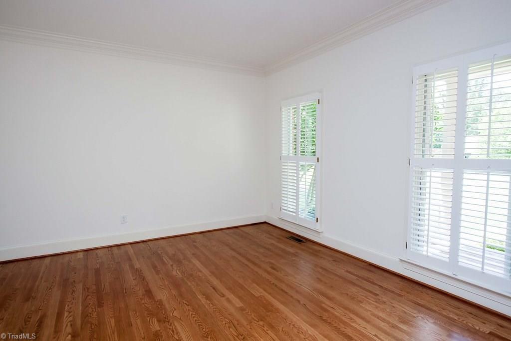 6104 Gwynedd Road Summerfield, NC 27358 - Photo 5 of 30 Living room or could be used for first floor office. Plantation shutters are custom and convey.