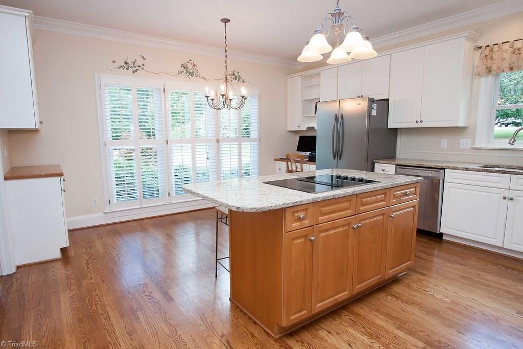 6104 Gwynedd Road Summerfield, NC 27358 - Photo 9 of 30 New granite countertops, great storage and a light filled working space will satisfy any cook!