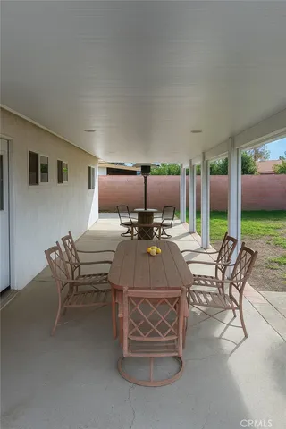 a living room with furniture a flat screen tv and a large window