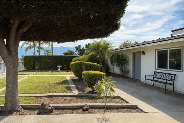 a backyard of a house with yard table and chairs