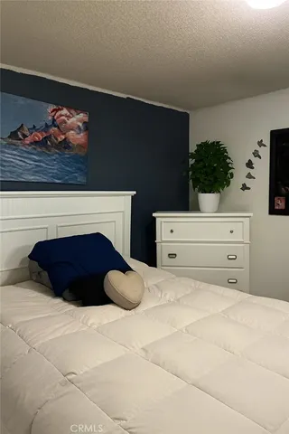 a room with a bed and a television