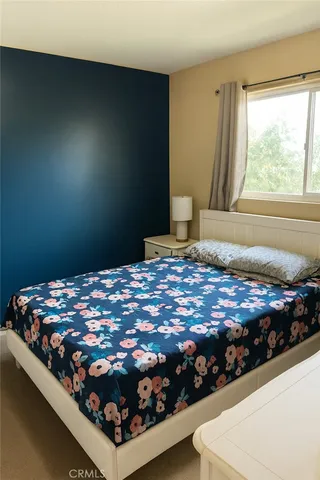 a bedroom with a bed and a window