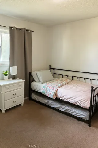 a bedroom with a bed and window