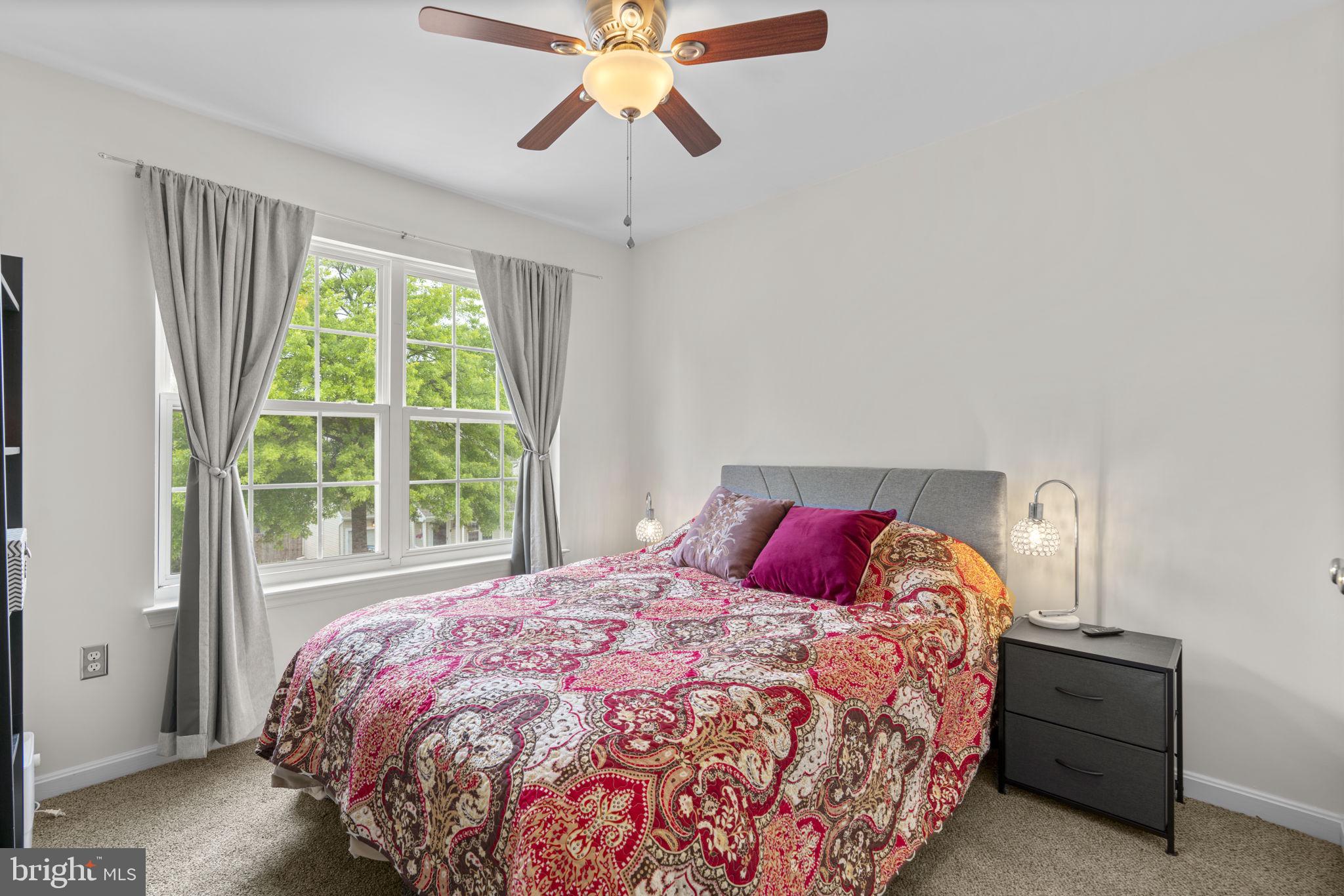 8057 Mayer Avenue Pasadena, MD 21122 - Photo 14 of 26 a bedroom with a bed and window