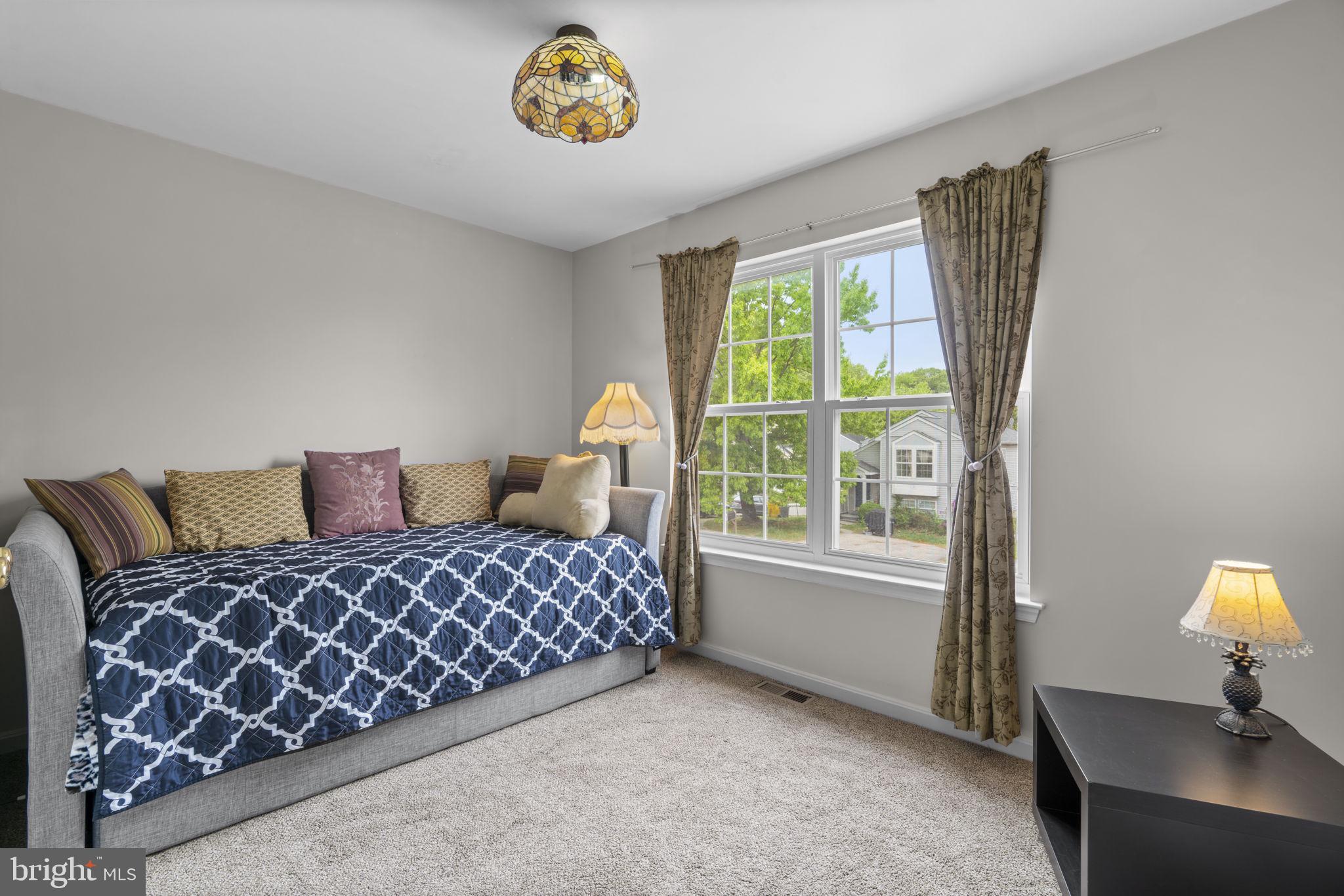 8057 Mayer Avenue Pasadena, MD 21122 - Photo 16 of 26 a bedroom with a bed and a window