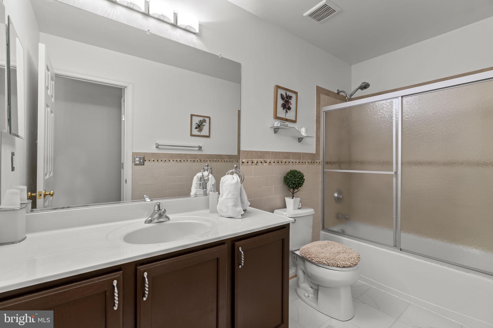 8057 Mayer Avenue Pasadena, MD 21122 - Photo 18 of 26 a bathroom with a sink a toilet and shower