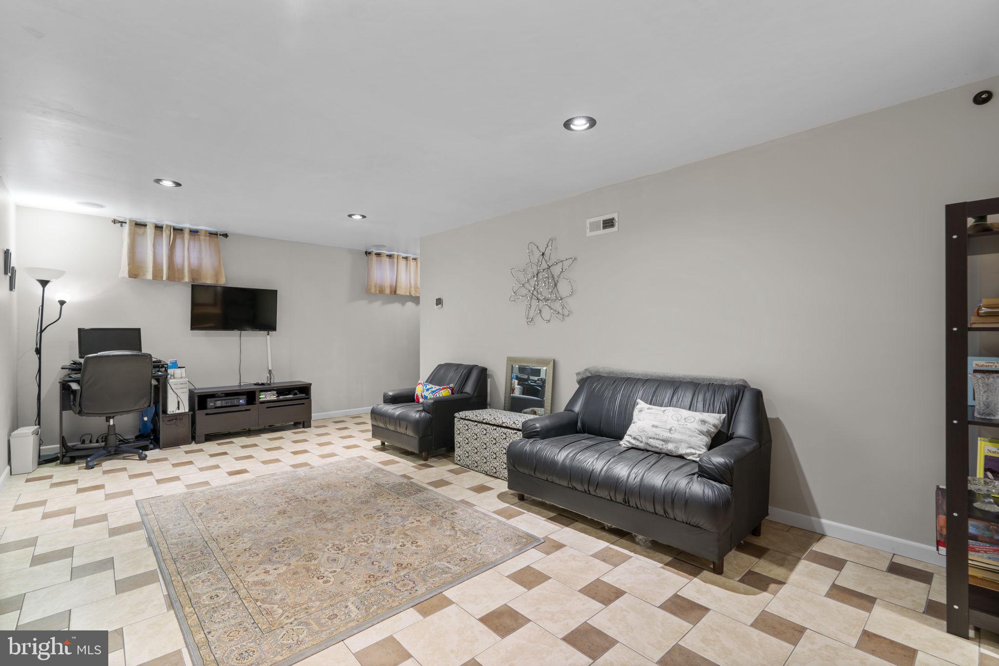 8057 Mayer Avenue Pasadena, MD 21122 - Photo 22 of 26 a living room with furniture and a flat screen tv